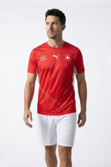 Man wearing a red sports jersey with a logo on a white background