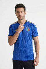 Man wearing a blue sports jersey with Italian flag design on a white background