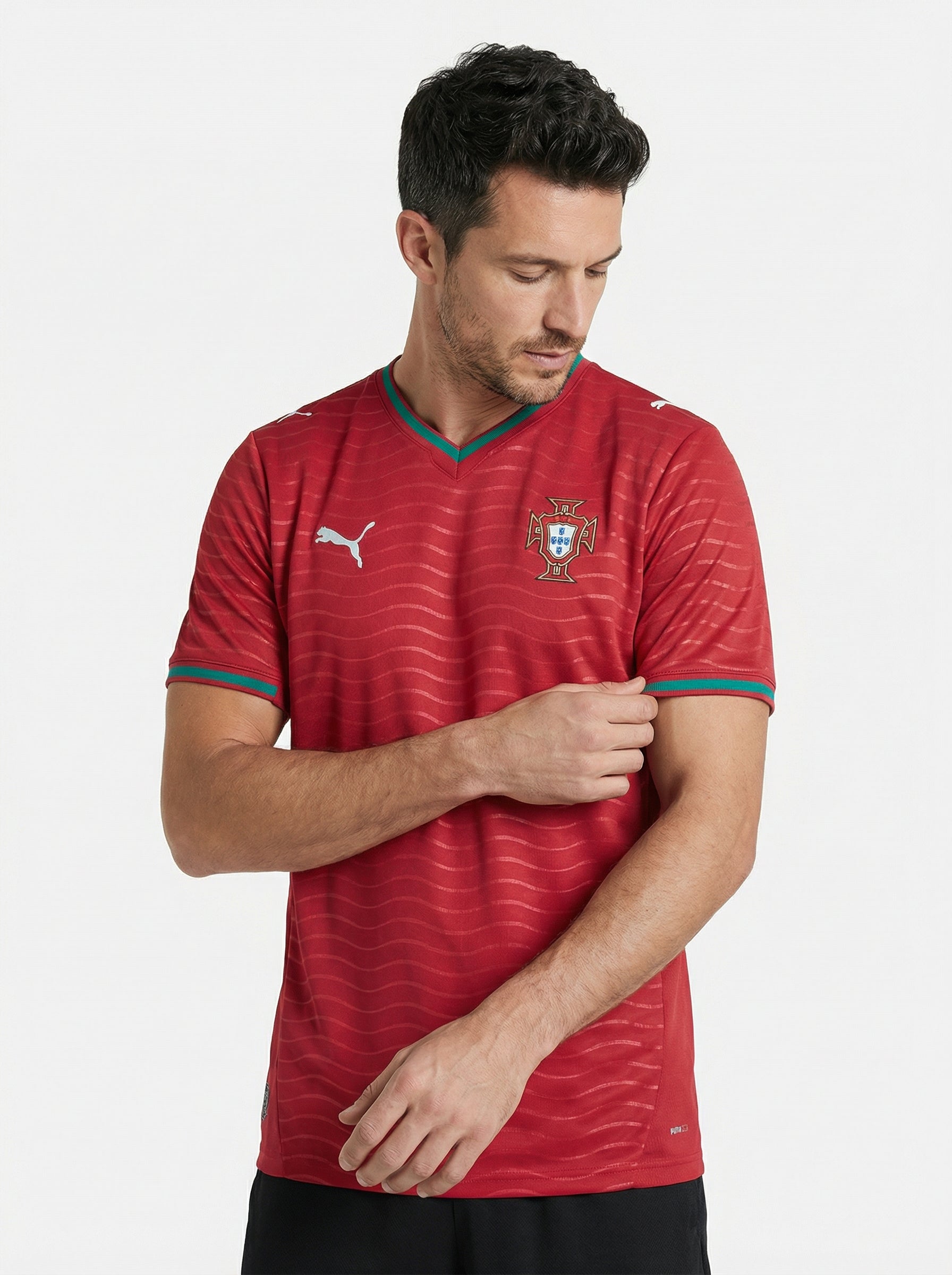 Man wearing a red sports jersey with a logo on a white background